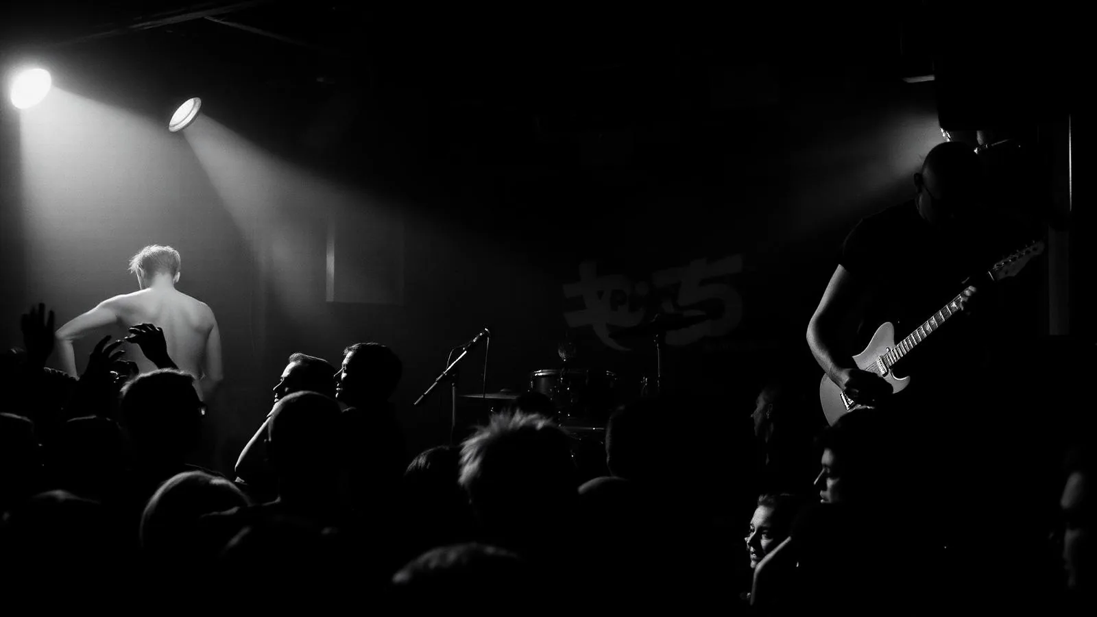 Punk band performing in a small Denver club